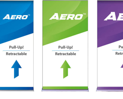 Aero retractable banner stands placed side by side, showing all four widths which are 24", 36", 48", and 60". Each Aero™ is upright with colorful sample trade show graphics and silver bases visible.