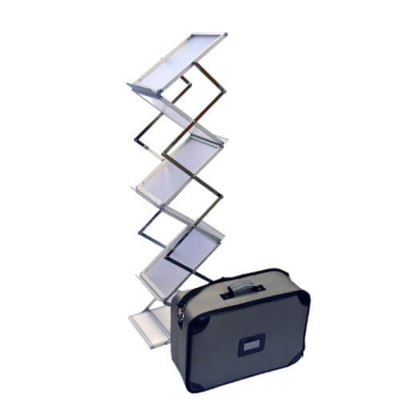 ProStack Folding Literature Rack, shown fully assembled with six silver metal pockets in a zigzag configuration, positioned next to a padded carry case featuring black corner reinforcements, a top handle, and a clear ID card holder on the front.
